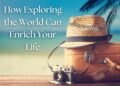 Travel essentials including a suitcase, straw hat, and vintage camera with a beach background.