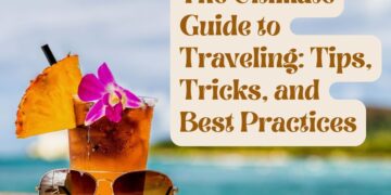 A refreshing tropical drink with a pineapple slice and a purple orchid flower next to sunglasses on a beach, with text overlay 'The Ultimate Guide to Traveling: Tips, Tricks, and Best Practices