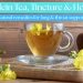 Clear glass cup of mullein tea with yellow mullein flowers on a wooden background – natural herbal remedy for lungs and throat