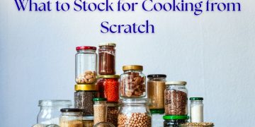 Glass jars filled with essential pantry staples like grains, beans, and spices for cooking from scratch.