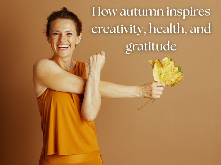 Smiling woman in warm autumn tones holding golden leaves, symbolizing autumn activities and seasonal wellbeing.